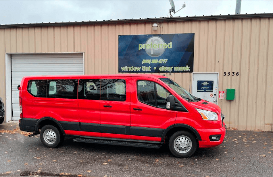Red van parked in front of Preferred Window Tint with untinted windows