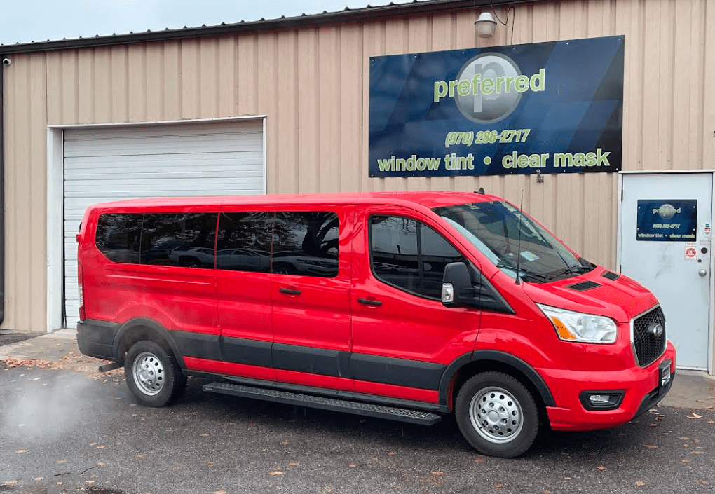 Red van parked in front of Preferred Window Tint with tinted windows 